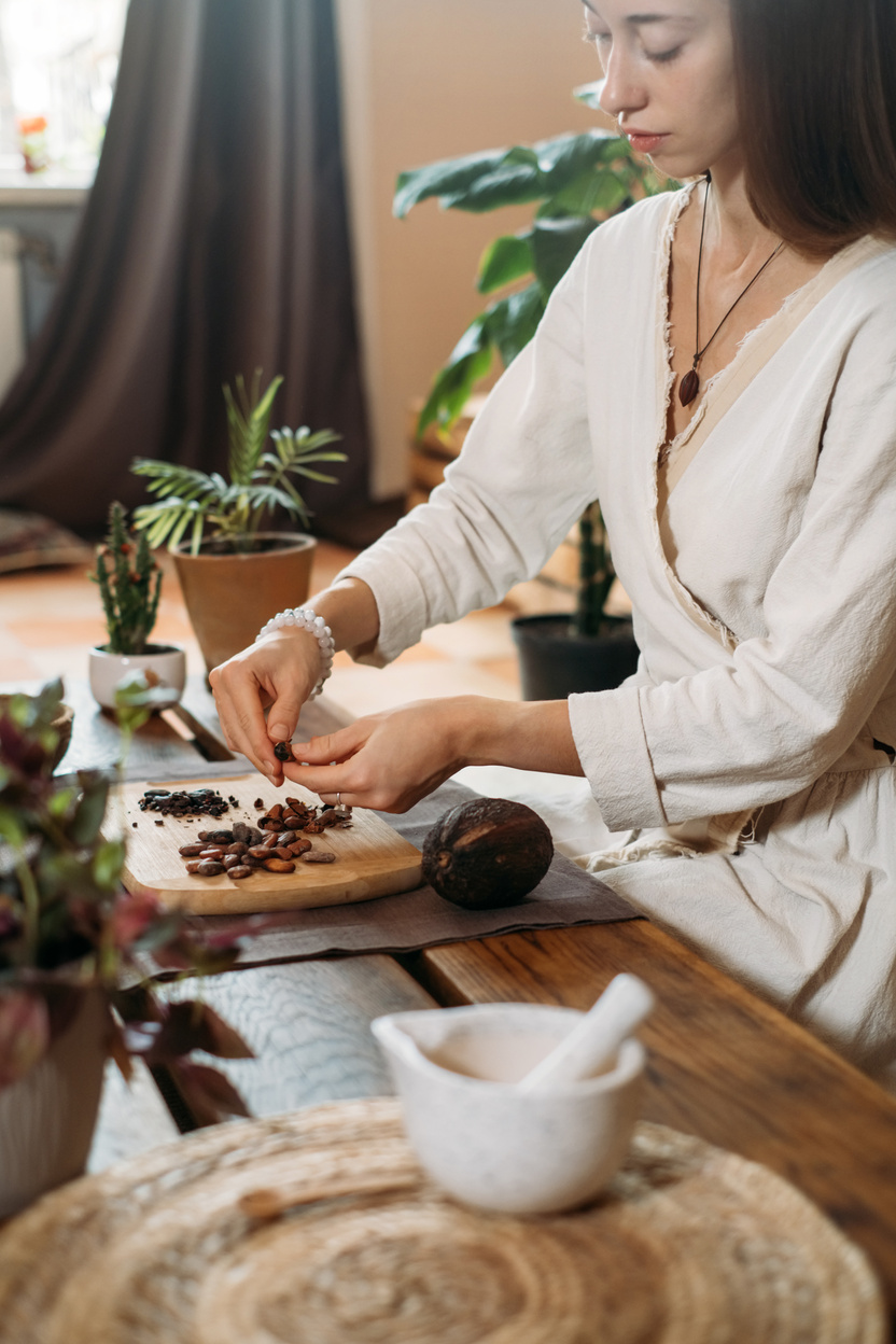 Woman Hands Peeling Raw Organic Cacao Beans for Ceremony